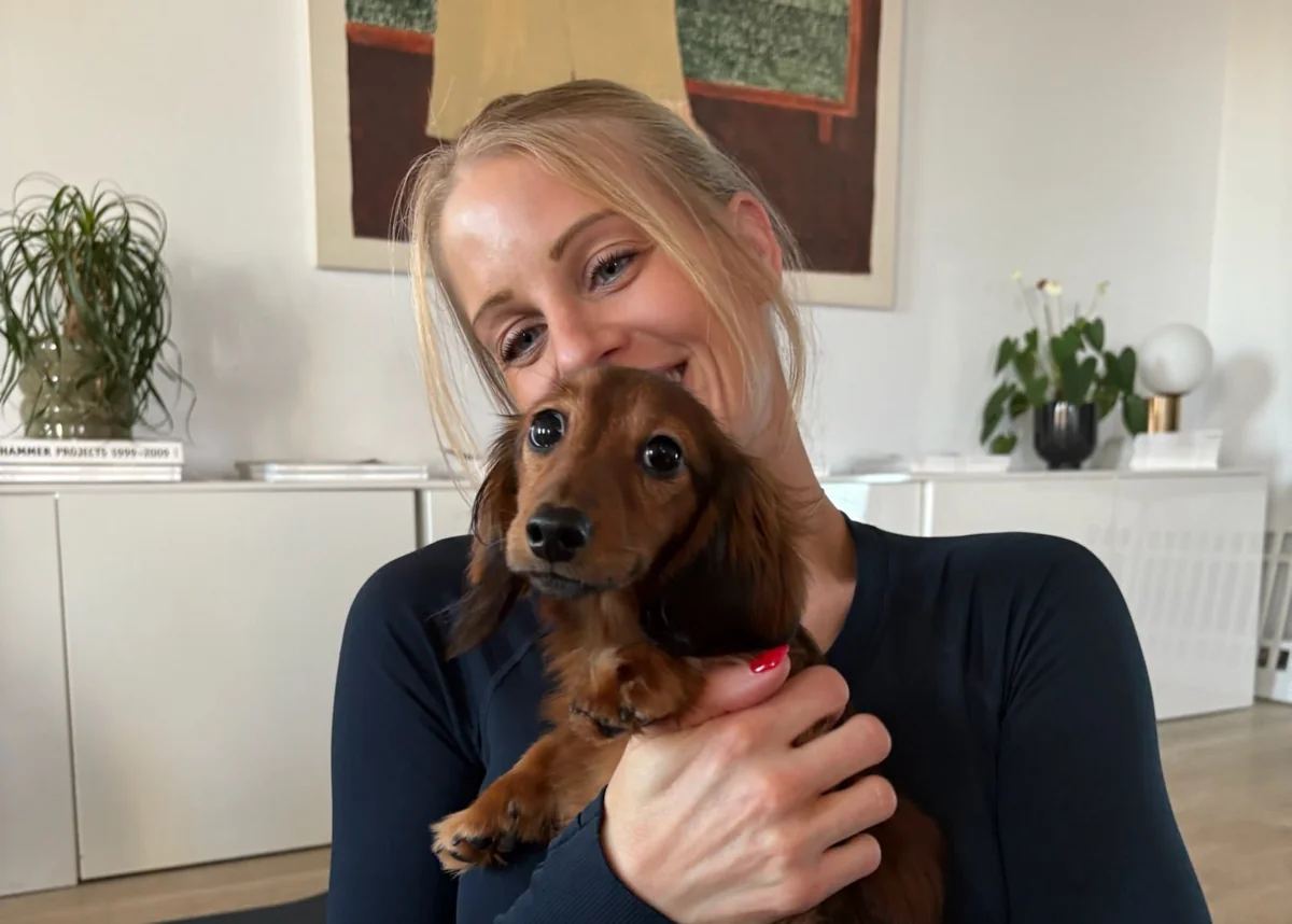 Person holding a puppy in a Pups&Yoga photo